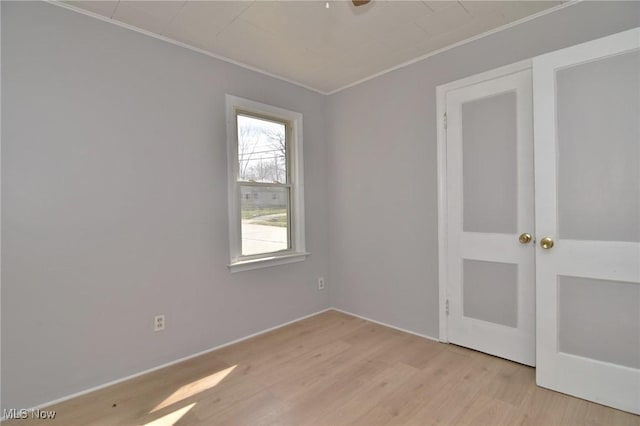 1118 Hartford Ave, Akron, OH 44320 - empty room with light wood-type flooring and ornamental molding