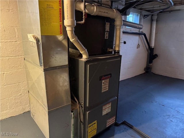 utility room featuring heating unit