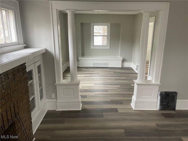 interior space featuring visible vents, plenty of natural light, and wood finished floors