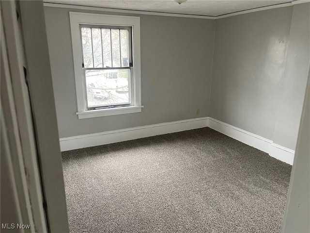 spare room featuring baseboards and a textured ceiling