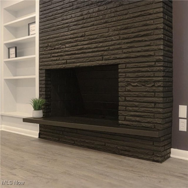 9171 Ridge Rd, North Royalton, OH 44133 - detailed view of wood finished floors, built in features, and a fireplace