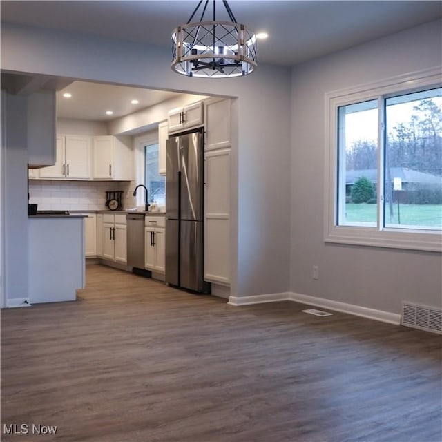 9171 Ridge Rd, North Royalton, OH 44133 - kitchen featuring appliances with stainless steel finishes, a chandelier, dark wood-style flooring, white cabinetry, and recessed lighting