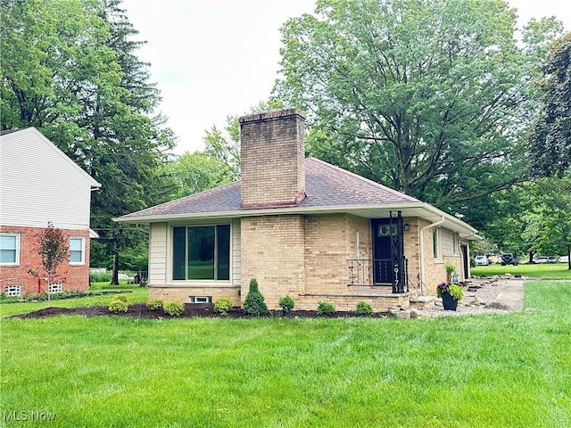 9171 Ridge Rd, North Royalton, OH 44133 - view of front of property with a chimney, a front yard, brick siding, and a shingled roof