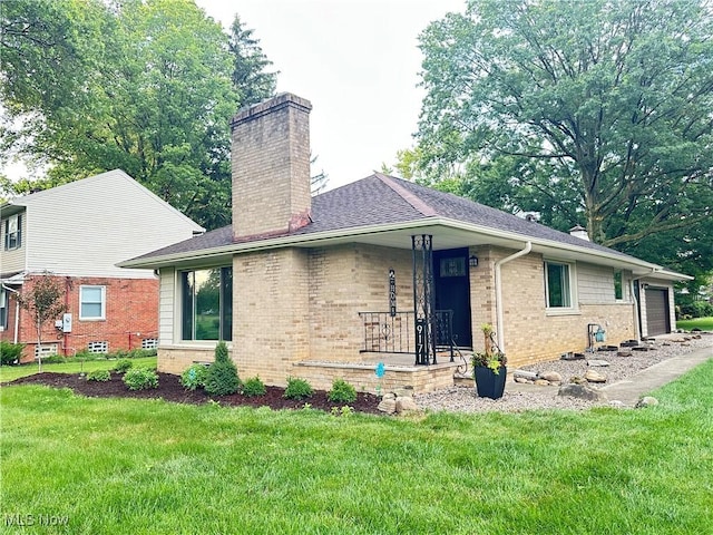 9171 Ridge Rd, North Royalton, OH 44133 - view of side of property with a chimney, brick siding, a lawn, and a garage