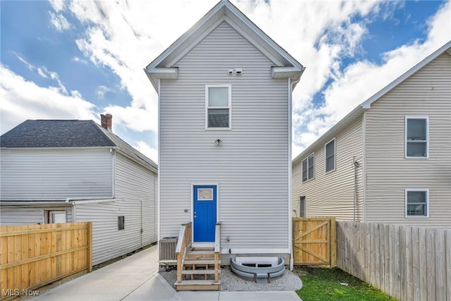 7510 Elton Ave, Cleveland, OH 44102 - rear view of house with a fenced backyard and entry steps