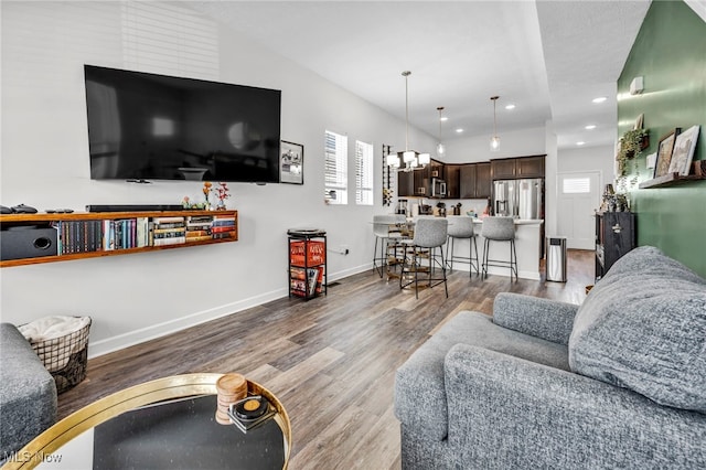 7510 Elton Ave, Cleveland, OH 44102 - living room featuring recessed lighting, baseboards, a chandelier, and wood finished floors