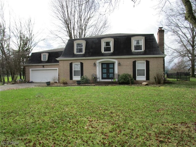 3701 Villa Marie Rd, Lowellville, OH 44436 - view of front of house featuring french doors, brick siding, driveway, and a garage