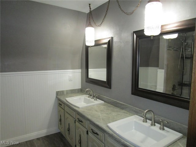 3701 Villa Marie Rd, Lowellville, OH 44436 - bathroom featuring double vanity, a sink, wainscoting, and wood finished floors