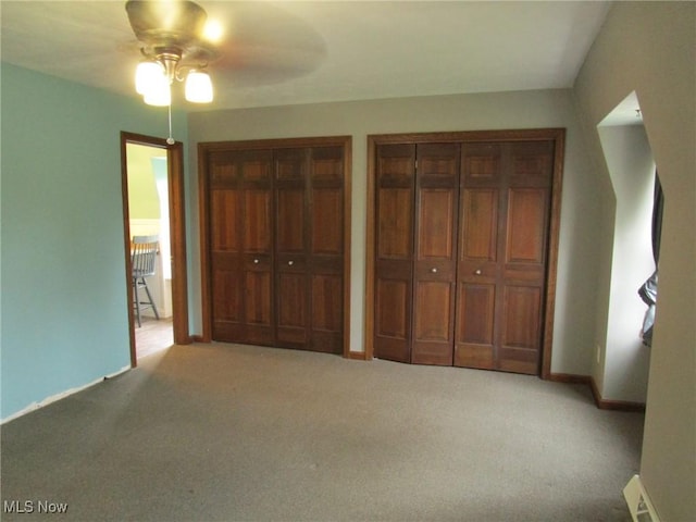 3701 Villa Marie Rd, Lowellville, OH 44436 - unfurnished bedroom with carpet floors, baseboards, visible vents, two closets, and ceiling fan