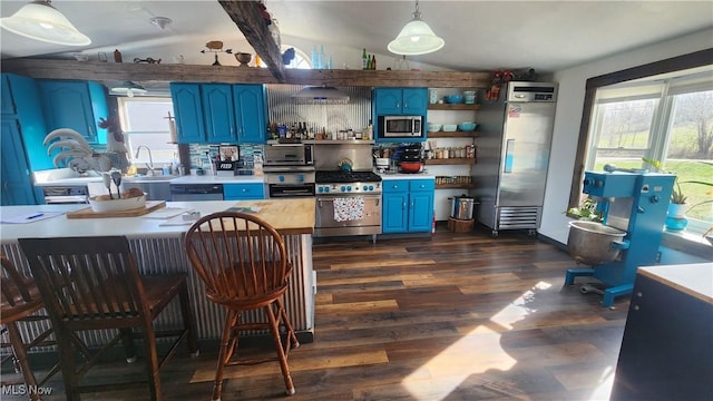53525 Somerton Hwy, Jerusalem, OH 43747 - kitchen with blue cabinets, stainless steel appliances, lofted ceiling, dark wood-style floors, and open shelves