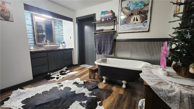 53525 Somerton Hwy, Jerusalem, OH 43747 - bathroom featuring vanity, a freestanding bath, and wood finished floors