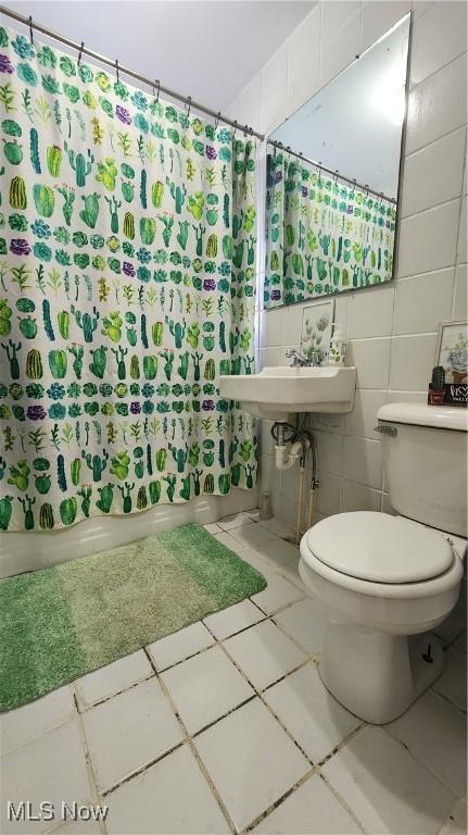 53525 Somerton Hwy, Jerusalem, OH 43747 - bathroom featuring tile walls, toilet, shower / bath combo with shower curtain, tile patterned flooring, and a sink