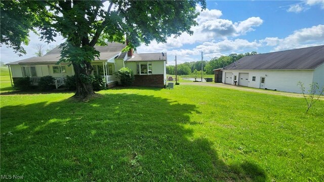 53525 Somerton Hwy, Jerusalem, OH 43747 - view of grassy yard with driveway and an attached garage