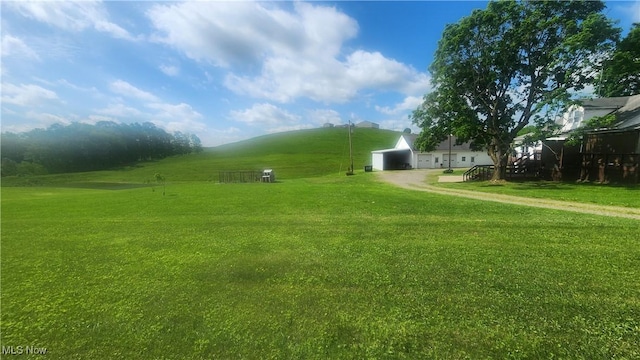53525 Somerton Hwy, Jerusalem, OH 43747 - view of home's community featuring dirt driveway, a detached garage, and a lawn