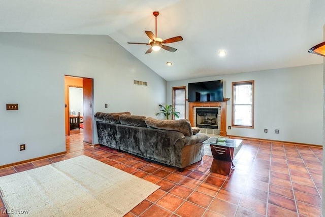 living room featuring high vaulted ceiling, tile patterned floors, visible vents, a ceiling fan, and a fireplace