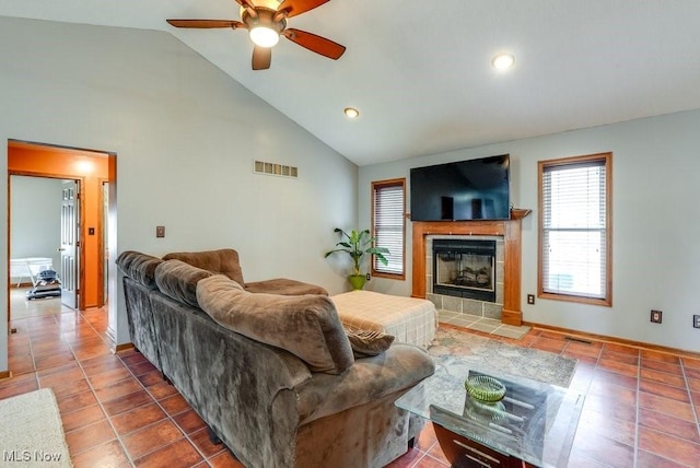 living room with tile patterned floors, a fireplace, visible vents, and a ceiling fan