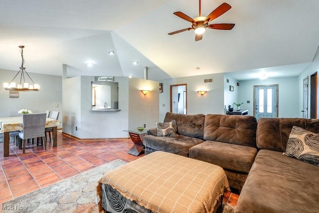 tiled living area with ceiling fan with notable chandelier, lofted ceiling, and visible vents