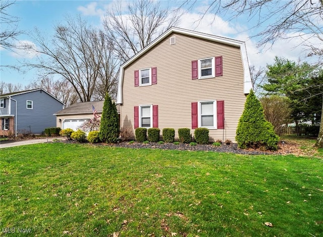 view of front facade featuring driveway, a front yard, and a gambrel roof