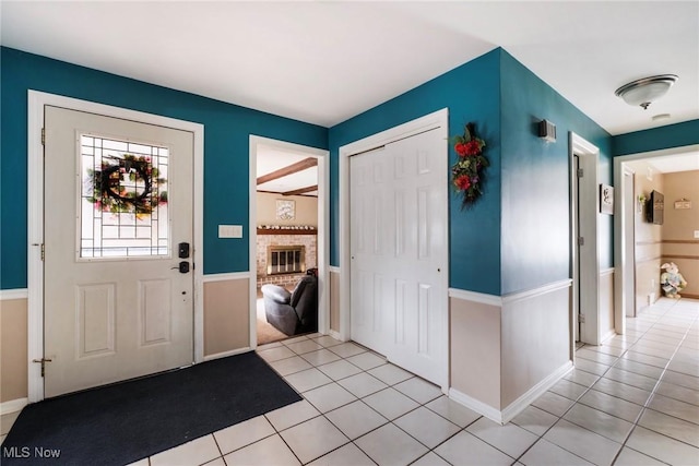 foyer entrance featuring baseboards and light tile patterned floors