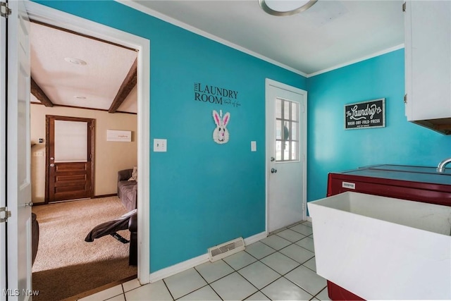 interior space with baseboards, ornamental molding, and visible vents