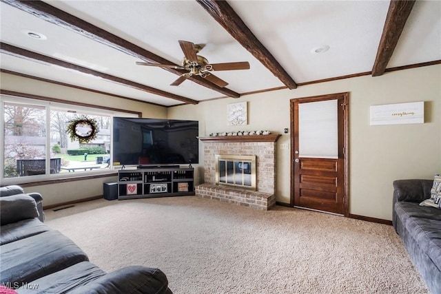living area with carpet flooring, baseboards, ceiling fan, and beamed ceiling