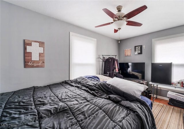 bedroom with ceiling fan and wood finished floors