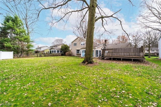 view of yard with fence and a deck