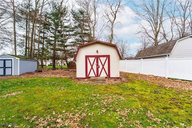view of shed featuring fence