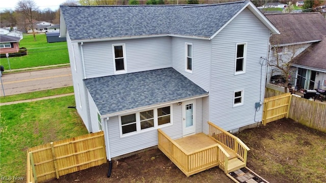 rear view of house with a shingled roof