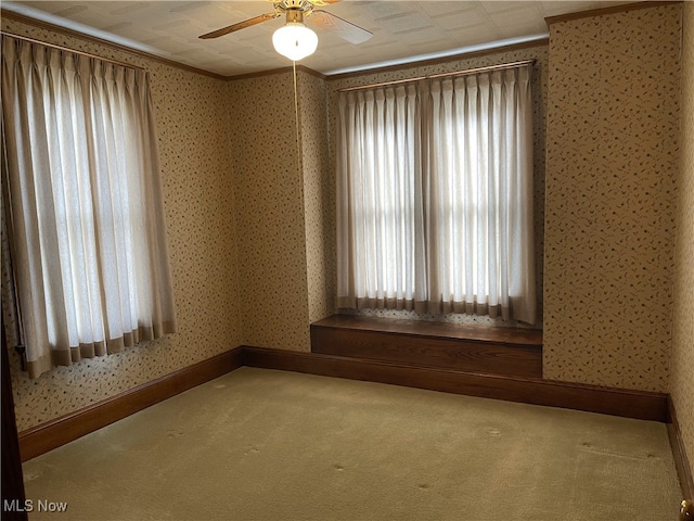 23314 Frostyville Rd, Caldwell, OH 43724 - empty room featuring carpet flooring, wallpapered walls, ornamental molding, and ceiling fan