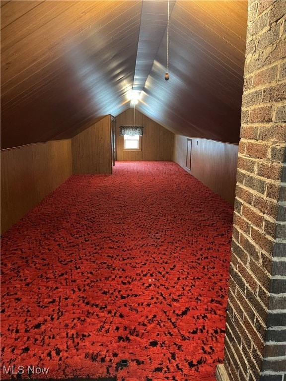 23314 Frostyville Rd, Caldwell, OH 43724 - additional living space with lofted ceiling, wooden walls, and carpet flooring
