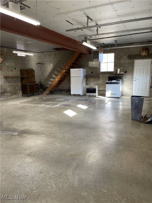 23314 Frostyville Rd, Caldwell, OH 43724 - garage featuring freestanding refrigerator and concrete block wall