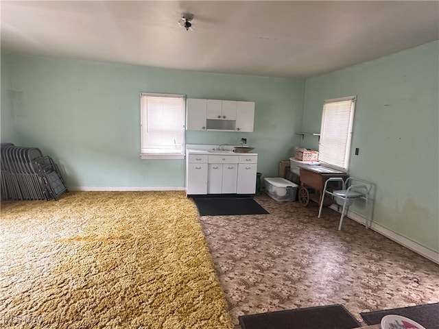 23314 Frostyville Rd, Caldwell, OH 43724 - kitchen featuring baseboards, white cabinetry, light countertops, and carpet