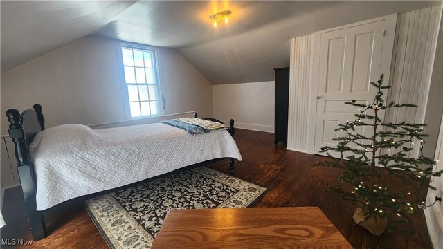 228 N 8th St, Coshocton, OH 43812 - bedroom featuring baseboards, vaulted ceiling, and wood finished floors