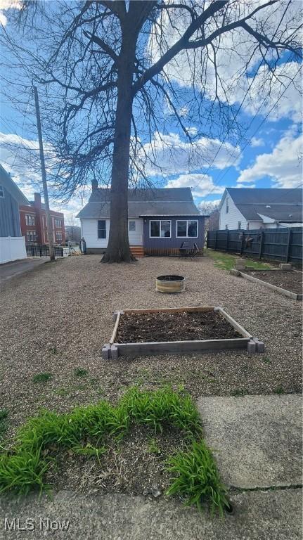228 N 8th St, Coshocton, OH 43812 - exterior space with a vegetable garden and fence