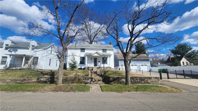 228 N 8th St, Coshocton, OH 43812 - view of front of house with a gate, fence, concrete driveway, and a garage