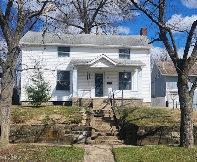 228 N 8th St, Coshocton, OH 43812 - view of front of house with covered porch and a chimney