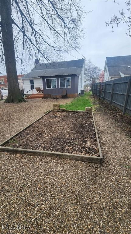 228 N 8th St, Coshocton, OH 43812 - exterior space with a garden, a deck, and fence