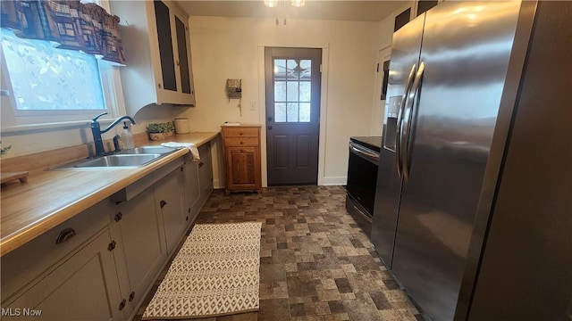 228 N 8th St, Coshocton, OH 43812 - kitchen featuring light countertops, a sink, stainless steel fridge with ice dispenser, white cabinetry, and electric stove