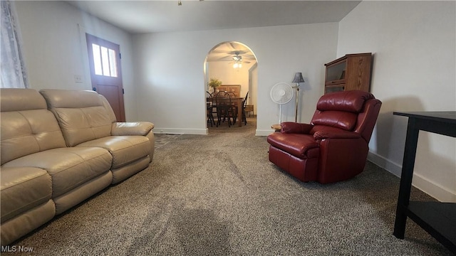 228 N 8th St, Coshocton, OH 43812 - carpeted living room featuring a ceiling fan, arched walkways, and baseboards
