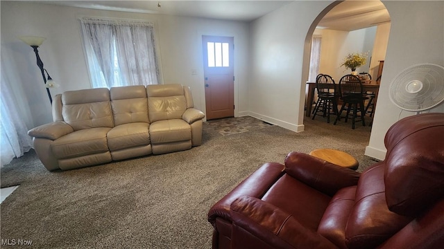 228 N 8th St, Coshocton, OH 43812 - living area featuring arched walkways, carpet flooring, and baseboards