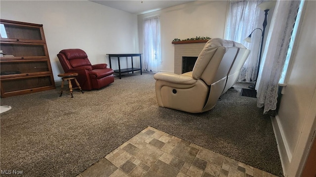 228 N 8th St, Coshocton, OH 43812 - living area with carpet floors, visible vents, a brick fireplace, and stone finish flooring