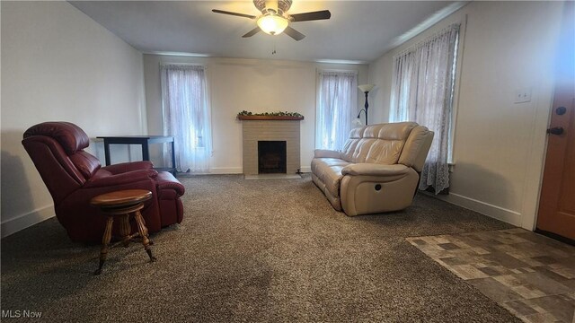 228 N 8th St, Coshocton, OH 43812 - sitting room featuring baseboards, ceiling fan, and a fireplace