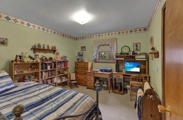 bedroom with carpet floors and a textured ceiling