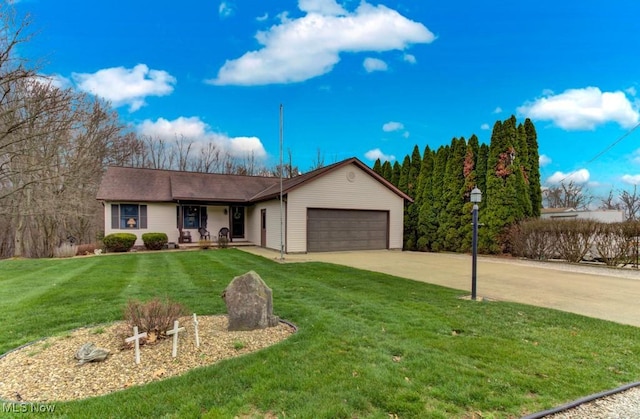 ranch-style home featuring a garage, concrete driveway, and a front yard