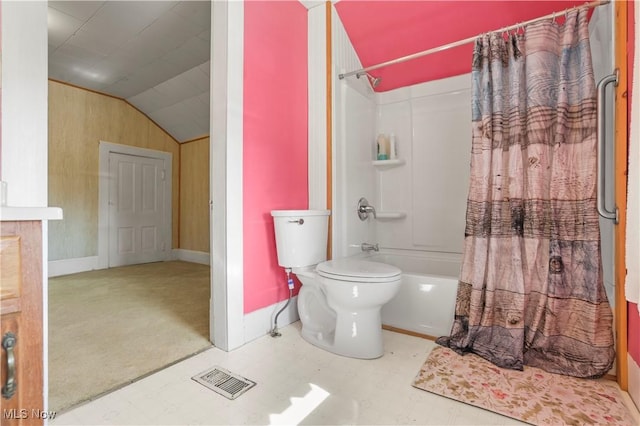 bathroom with vaulted ceiling, visible vents, toilet, and shower / bath combo with shower curtain