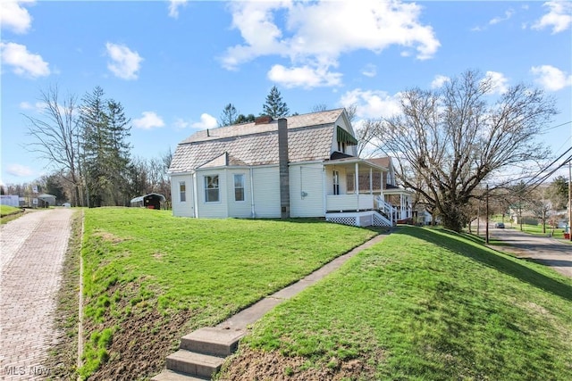view of property exterior featuring a porch and a lawn