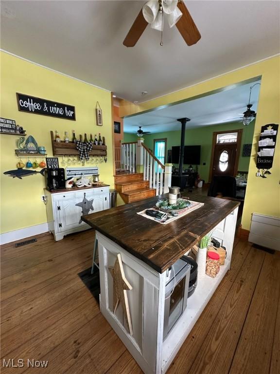 35955-35959 Bower Rd, Scio, OH 43988 - kitchen with visible vents, dark wood-style floors, a wood stove, and ceiling fan