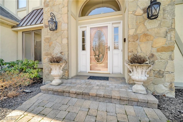 6722 Silvermound Dr, Mentor, OH 44060 - view of exterior entry featuring stone siding and a standing seam roof