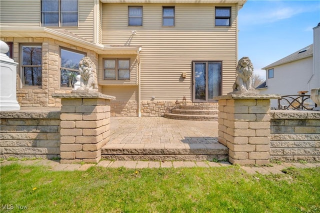 6722 Silvermound Dr, Mentor, OH 44060 - rear view of property featuring a patio area, stone siding, and entry steps